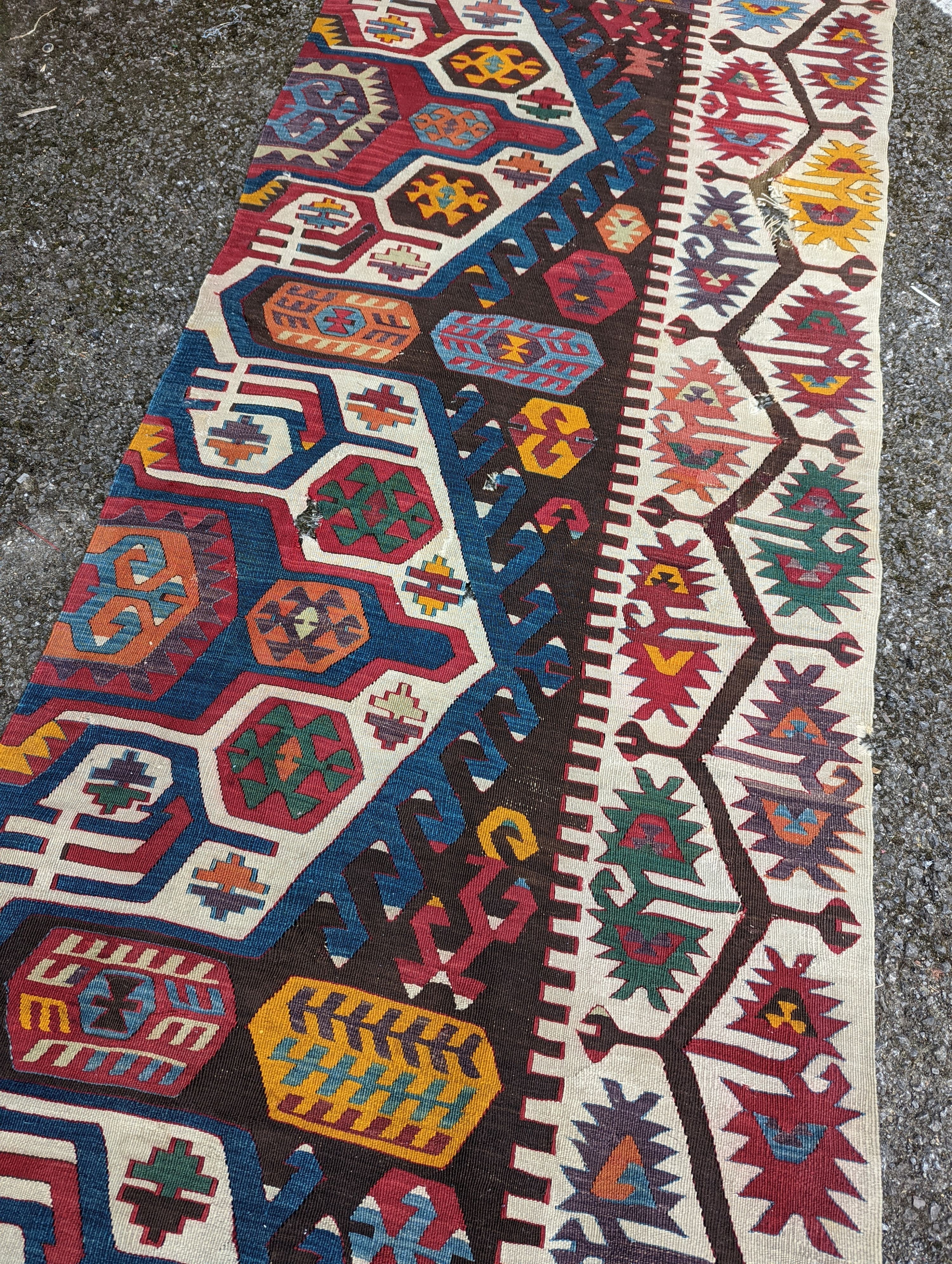 A large Kilim flatweave runner, 400 x 92cm (holed and cut)